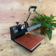 Photo of a heat press, with a plant for decorative purposes.